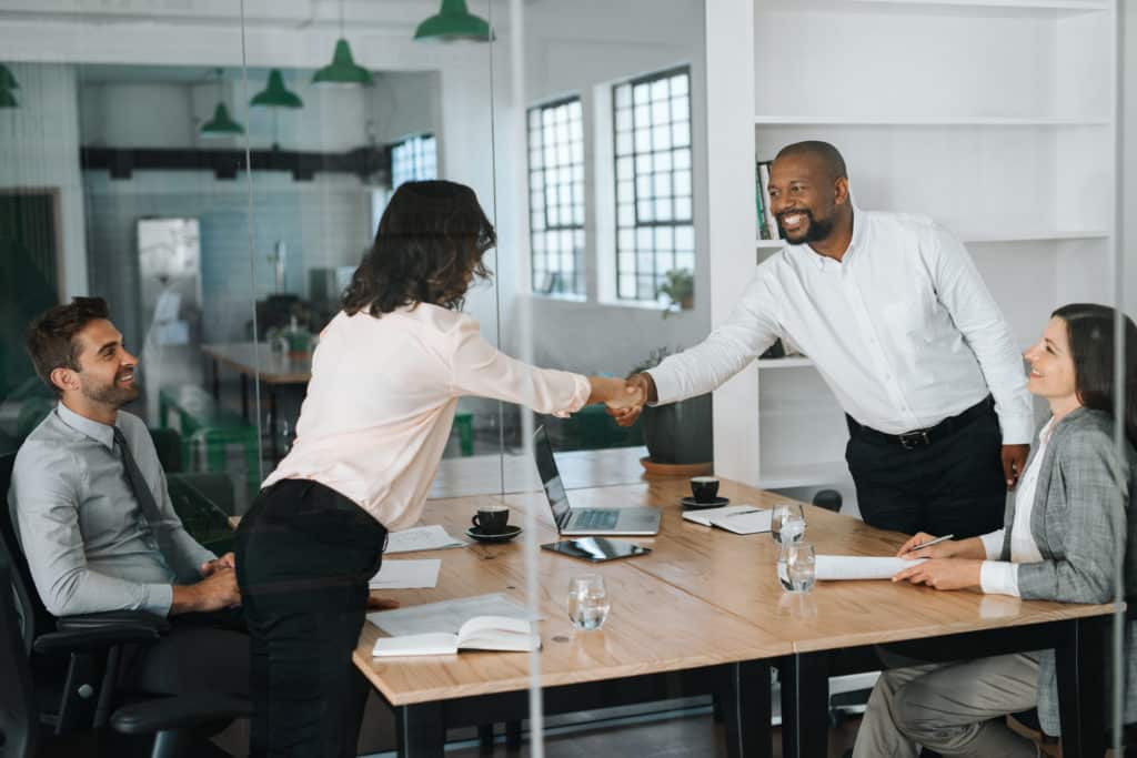 HR meeting business professionals in conference room shaking hands